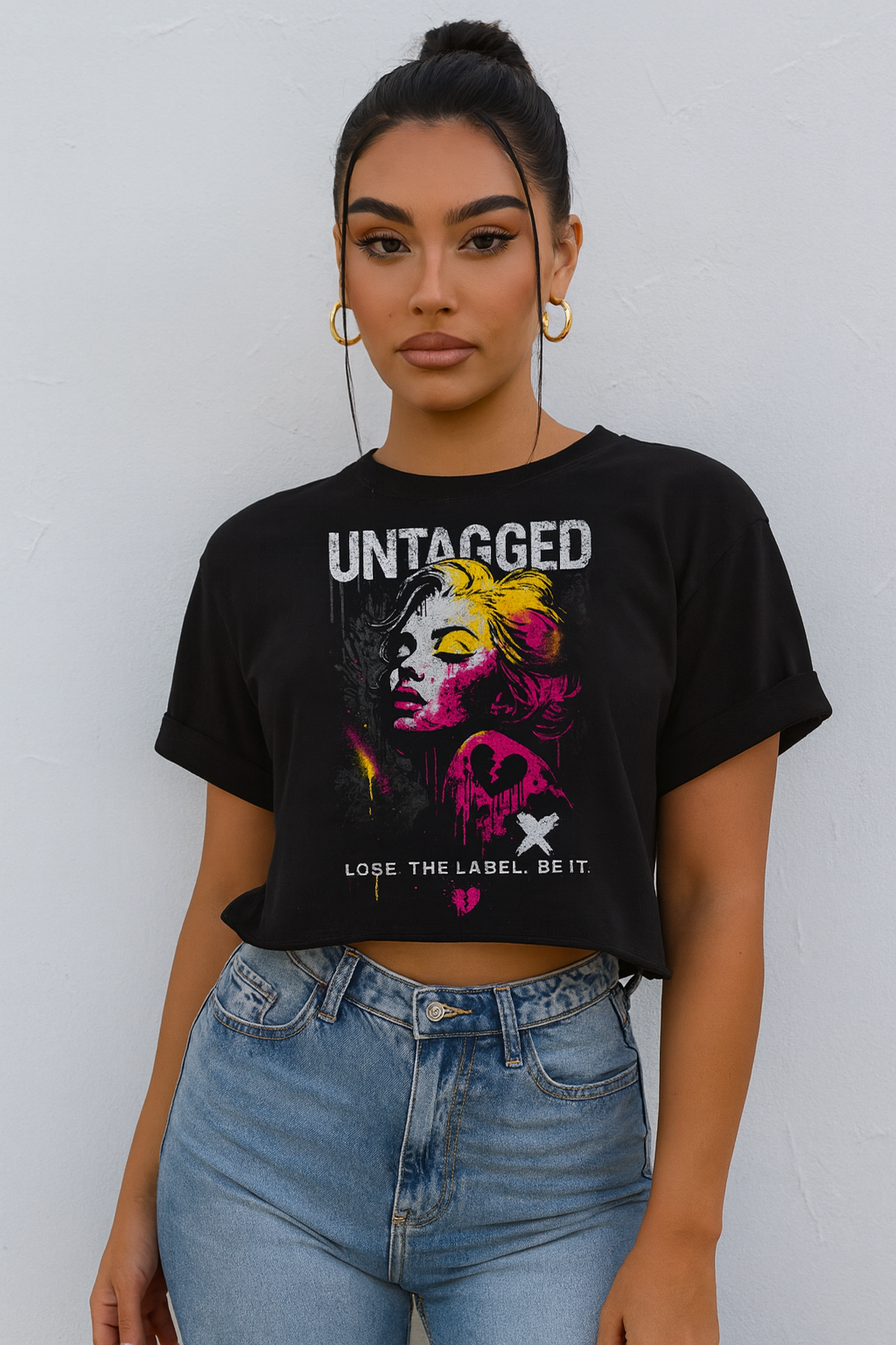 Person wearing a black t-shirt with graphic design and text against a plain background