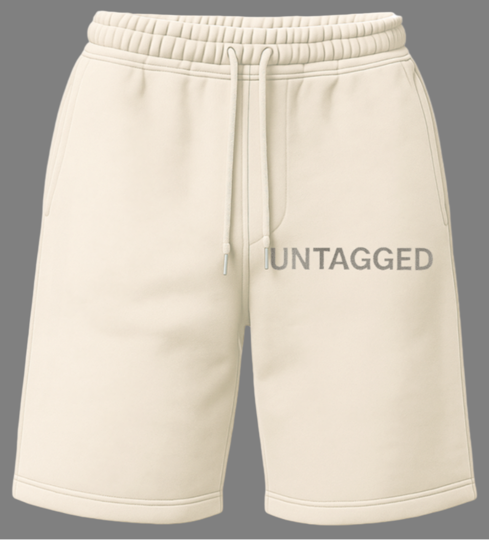 Beige sweat shorts on a gray background with 'UNTAGGED' text.