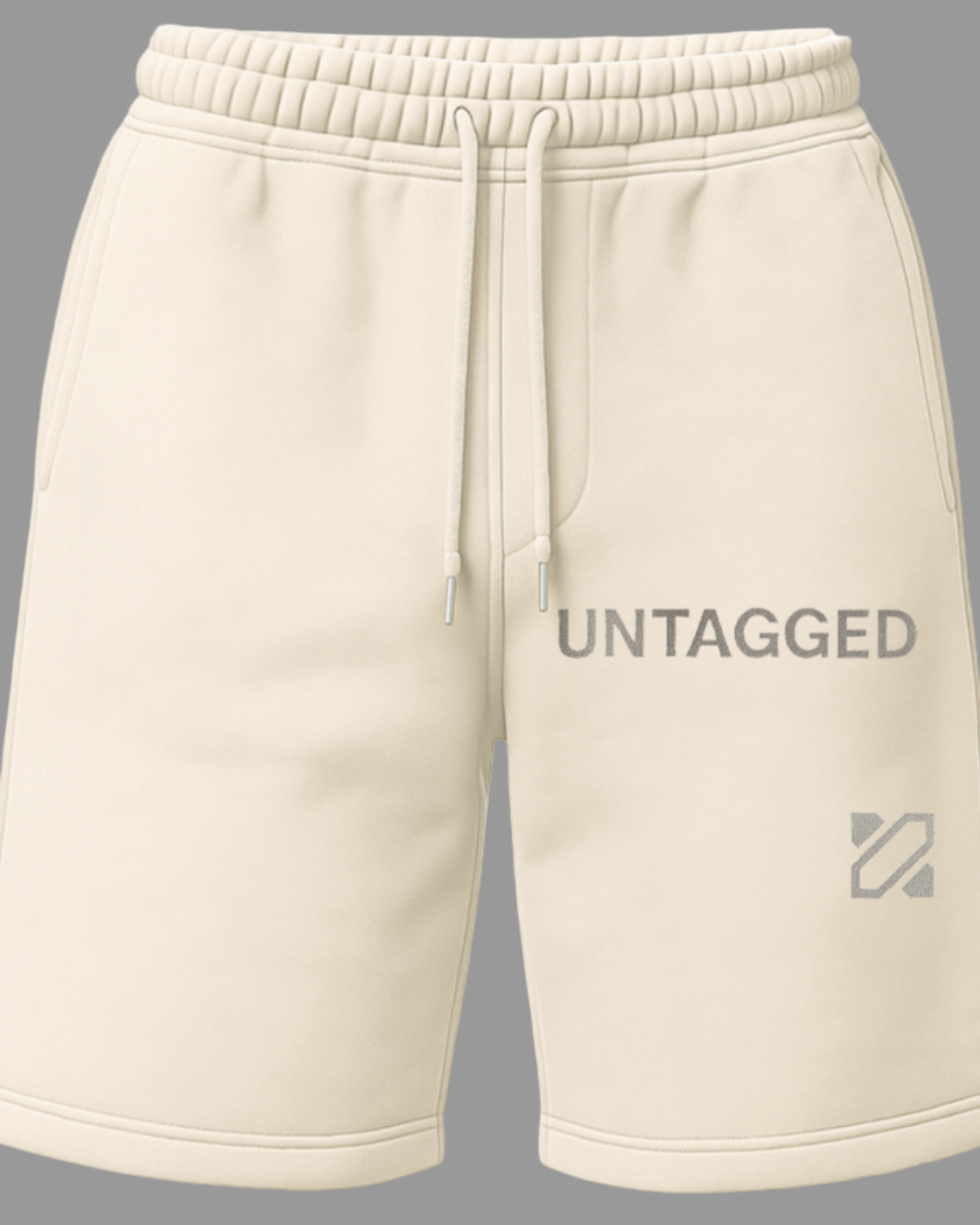 Beige shorts with 'Untagged' branding on a white background