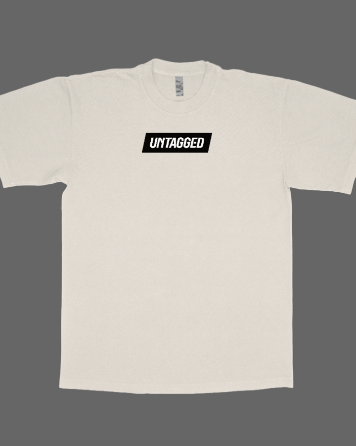 Beige t-shirt with 'UMTAGGED' logo on a white background