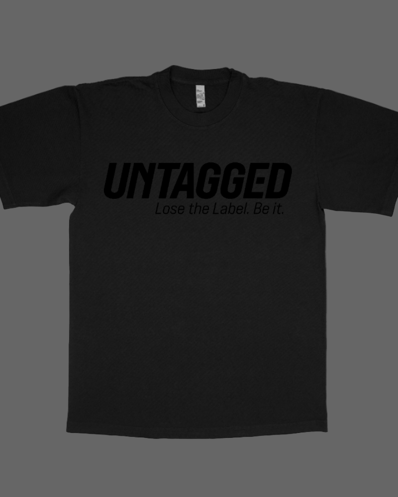 Black t-shirt with 'UNTAGGED Lose the Label. Be it' text on a white background
