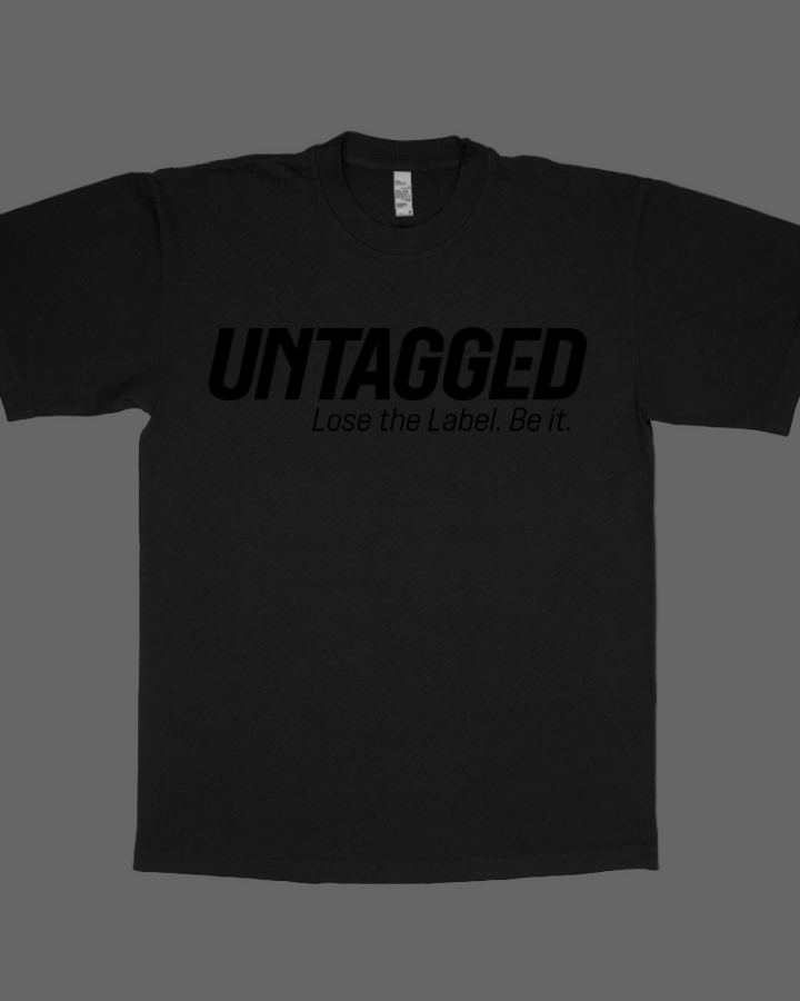 Black t-shirt with 'UNTAGGED Lose the Label. Be it' text on a white background