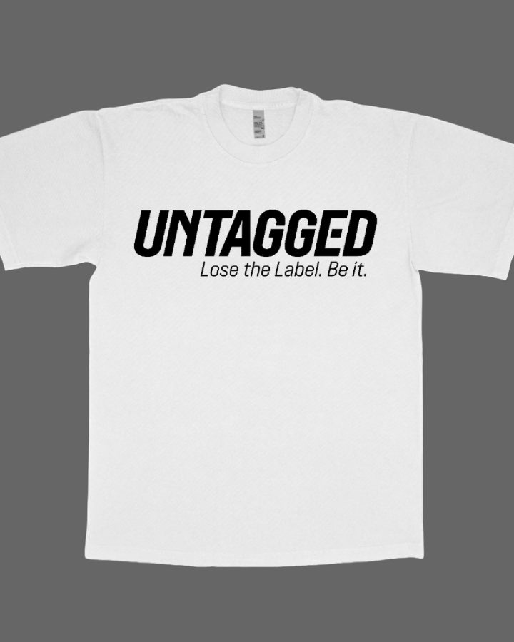 White t-shirt with 'UNTAGGED Lose the Label. Be it.' text on a white background