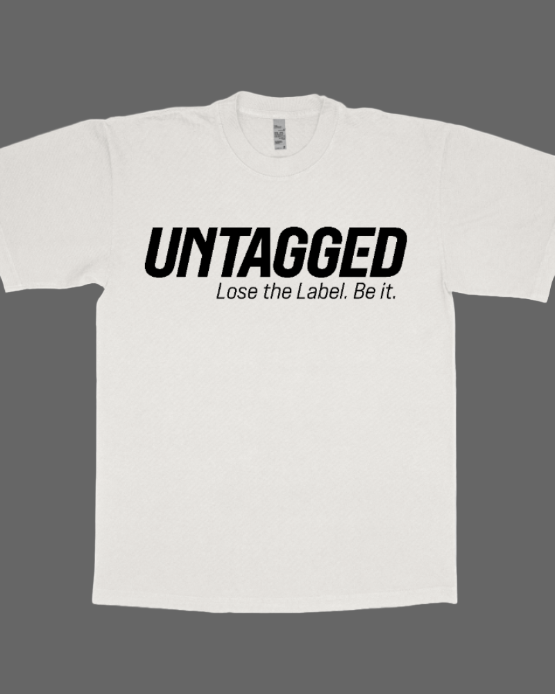 White t-shirt with 'UNTAGGED Lose the Label. Be it.' text on a white background