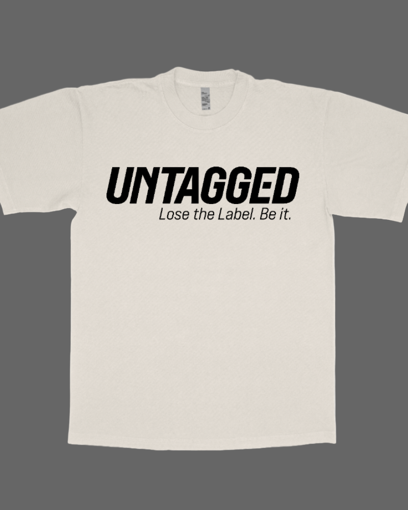 Beige t-shirt with 'UNTAGGED Lose the Label. Be it.' text on a white background