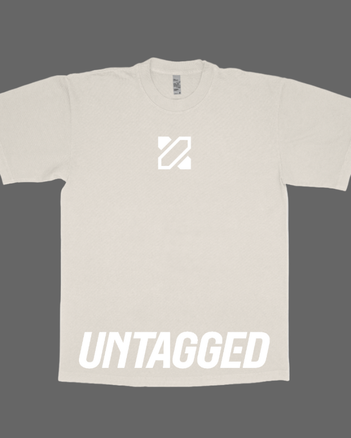 Beige t-shirt with a logo and 'UNTAGGED' text on a dark background