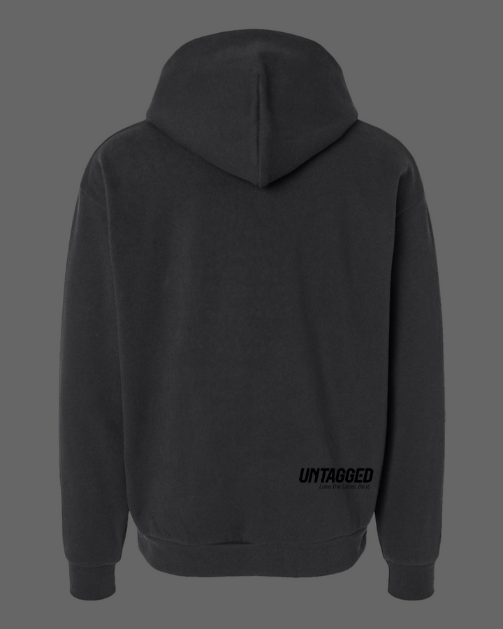 Black hoodie with 'UNTAGGED' text on the back against a white background