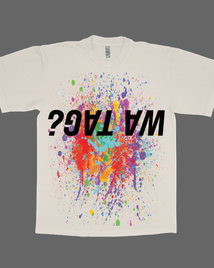 Beige t-shirt with colorful splatter design and 'WHAT?' text on a white background