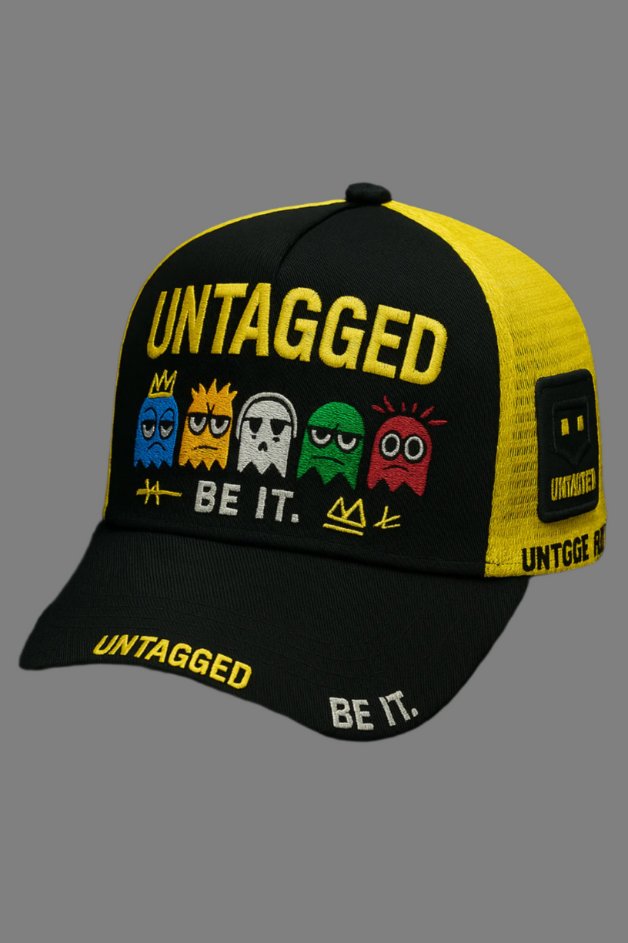 Black and yellow cap with 'Untagged' and 'Be It.' text on a black background - Pac-Man stye design