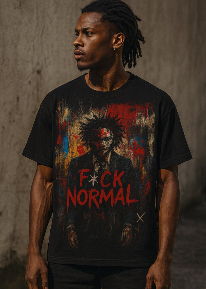 Person wearing a black t-shirt with a graphic design and text against a textured wall.