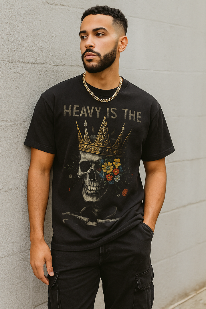 Man wearing a black t-shirt with a graphic design and text against a gray wall.