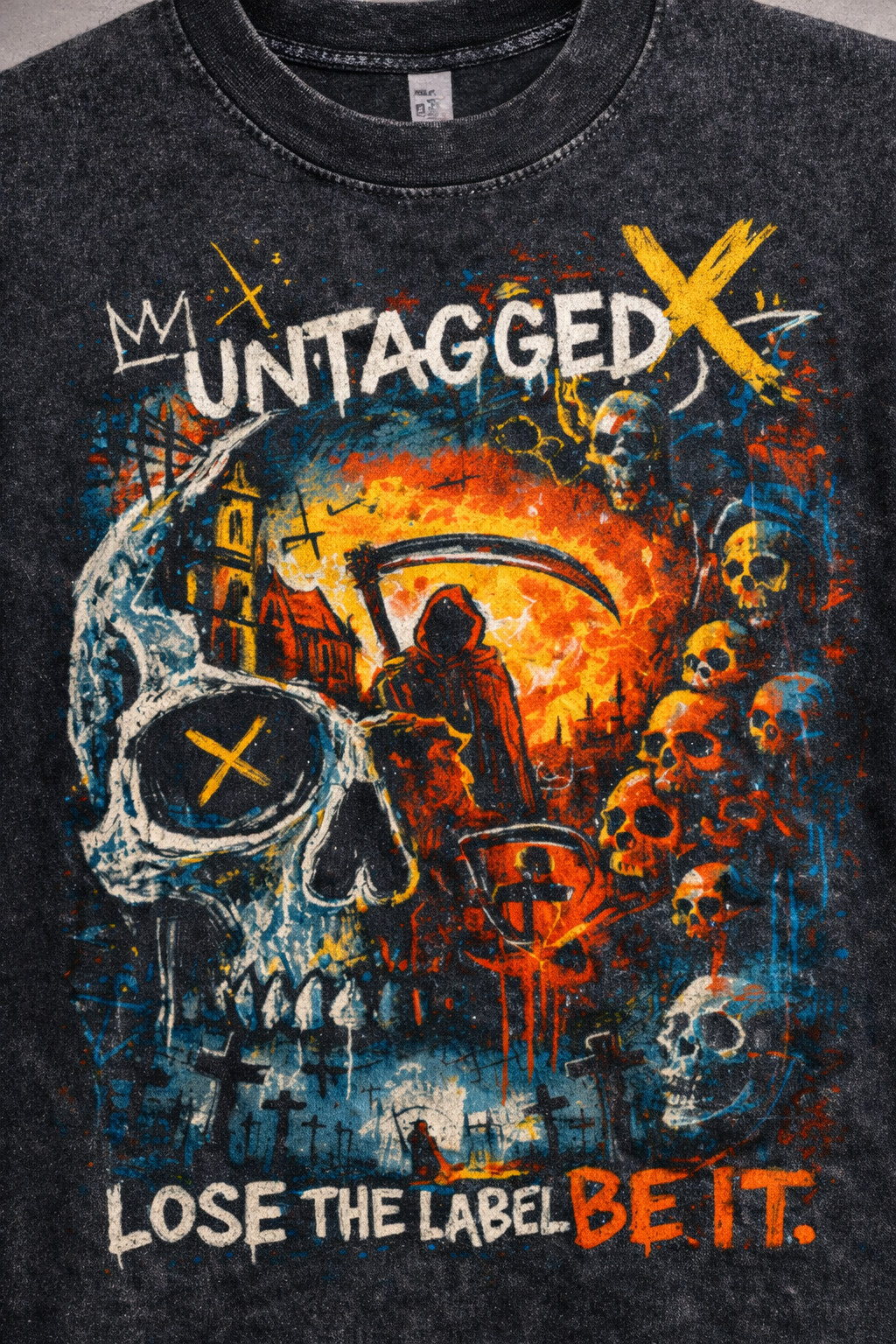 Black t-shirt with graphic design featuring skulls, a scythe, and text on a dark background