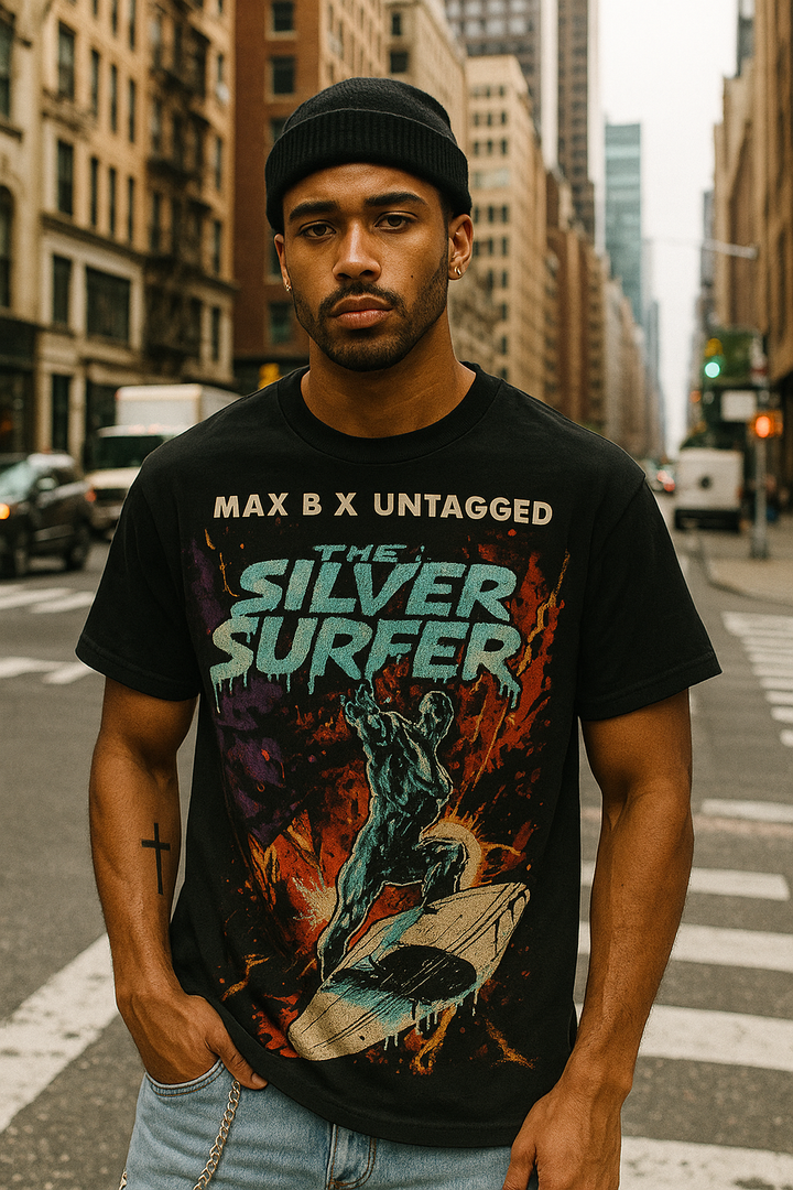 Man wearing a black t-shirt with 'The Silver Surfer' graphic design on a city street.