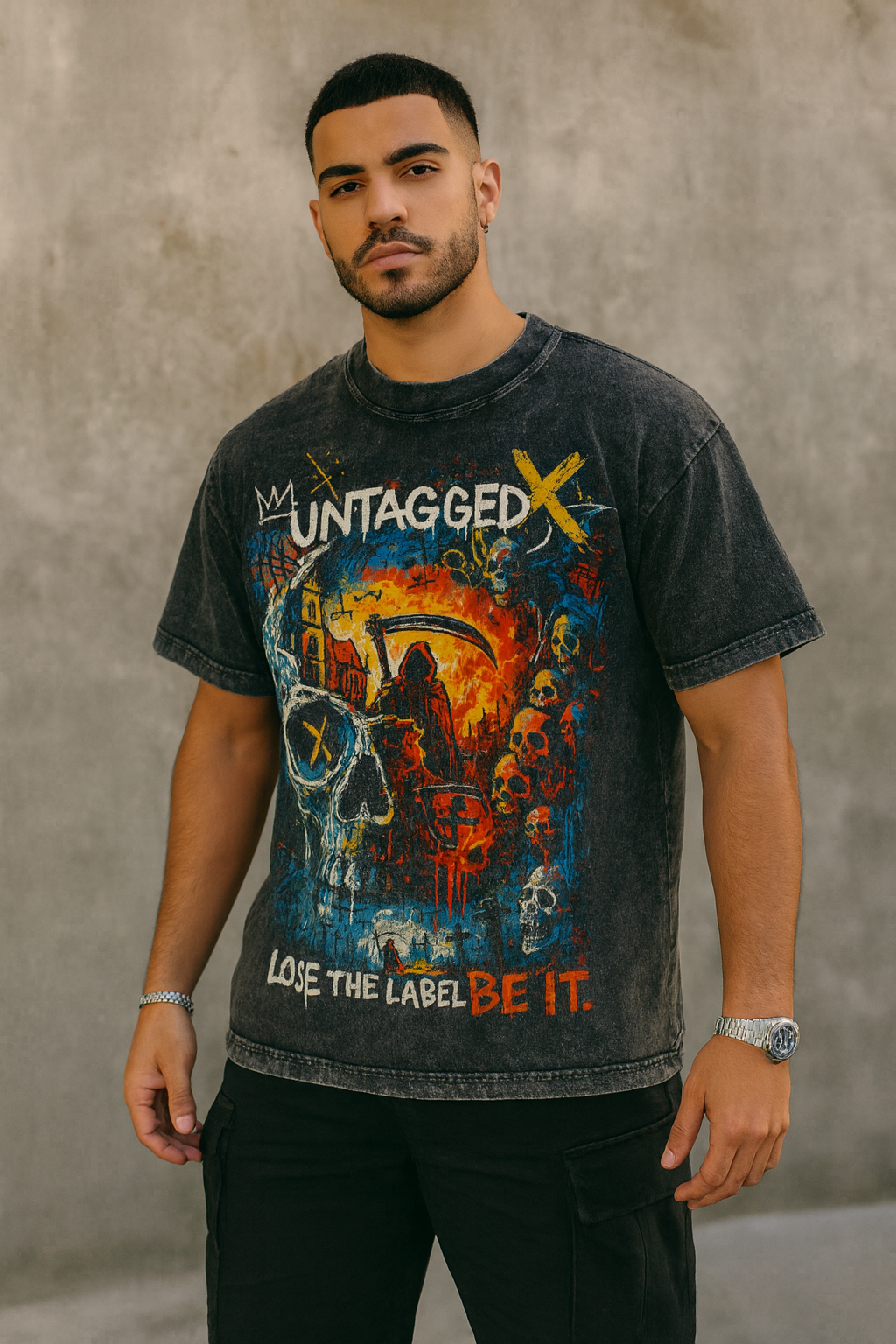 Man wearing a graphic t-shirt with a colorful design against a gray background