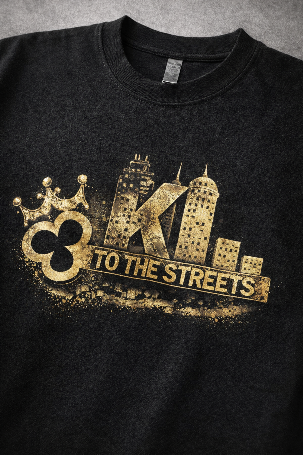 Black t-shirt with gold graphic design featuring text and architectural elements on a gray background