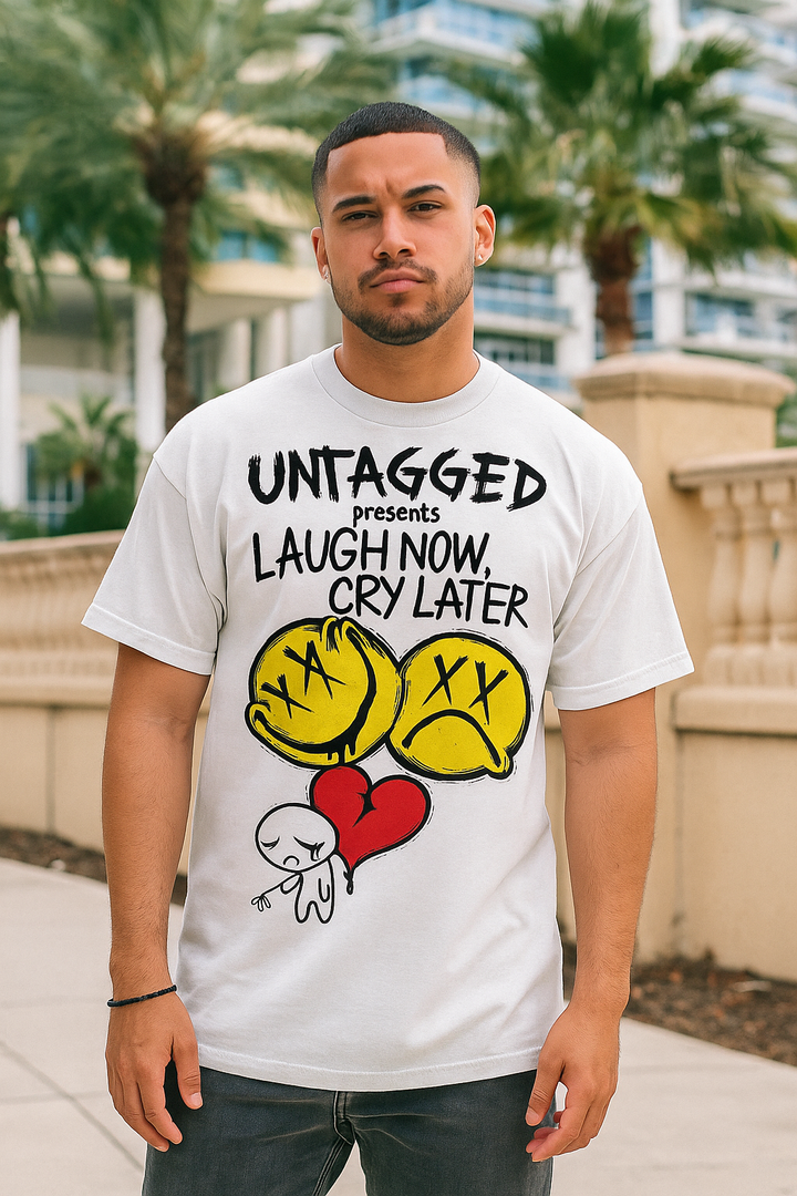 Man wearing a white t-shirt with graphic design and text in an outdoor setting