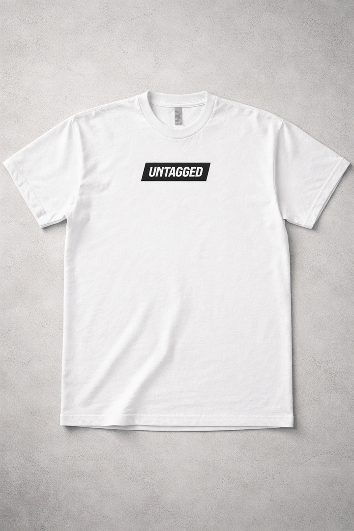 White t-shirt with 'Untagged' logo on a gray background