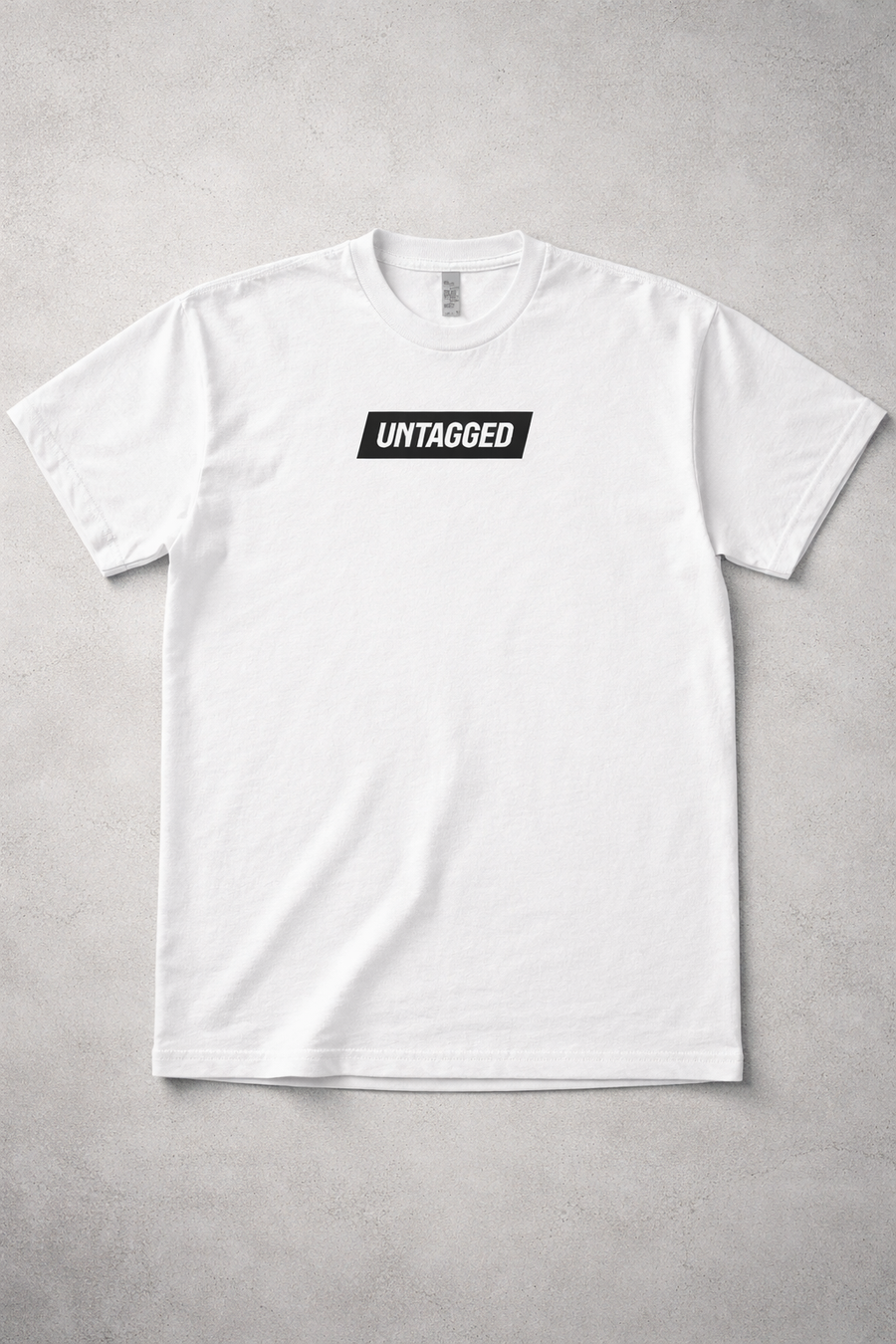 White t-shirt with 'Untagged' logo on a gray background