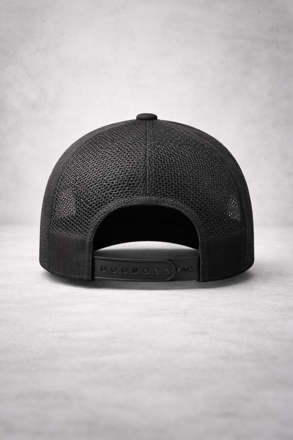 Black cap with mesh back on a light gray background