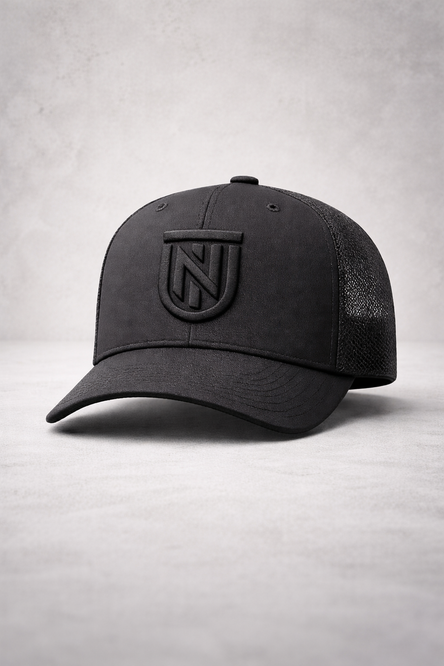 Black cap with a logo on a light gray background