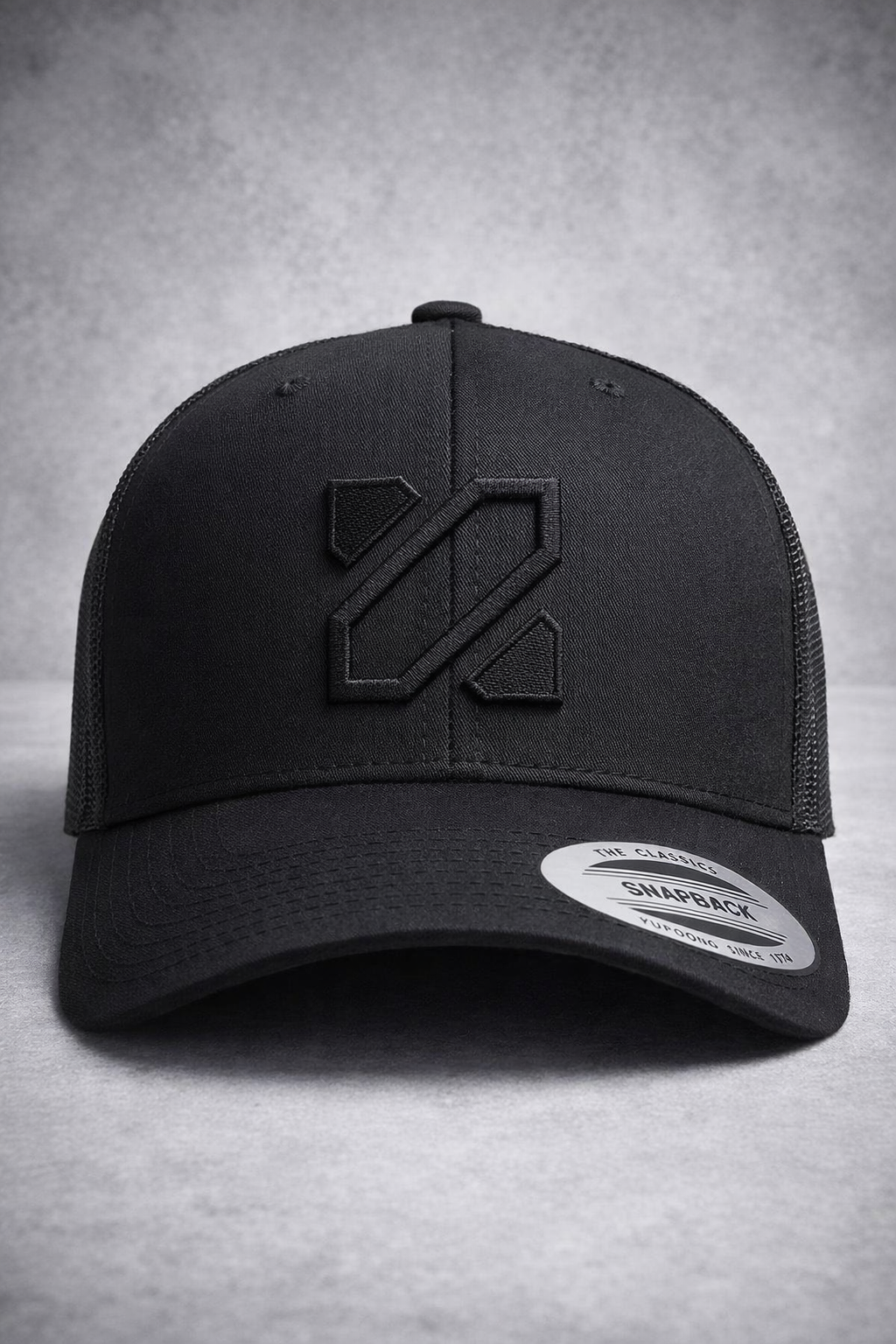 Black cap with a logo on a gray background