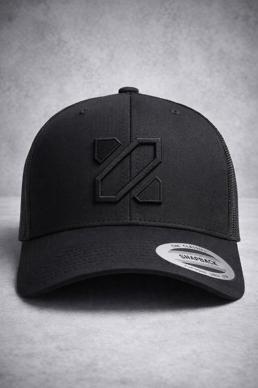 Black cap with a logo on a gray background